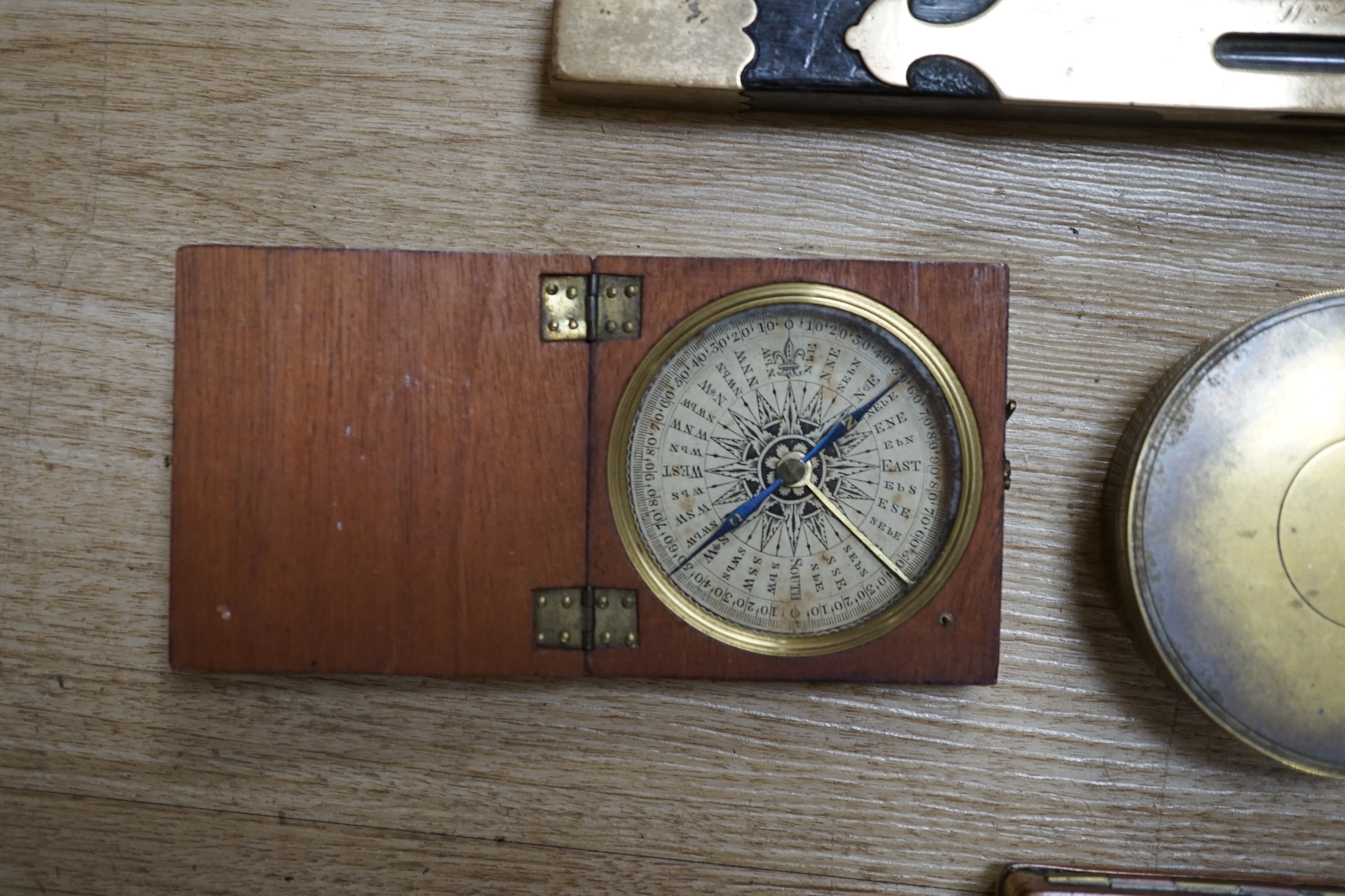 Two portable sundials, two brass inlaid spirit levels and a wood compass, wooden compass 34cm long. Condition - fair to good